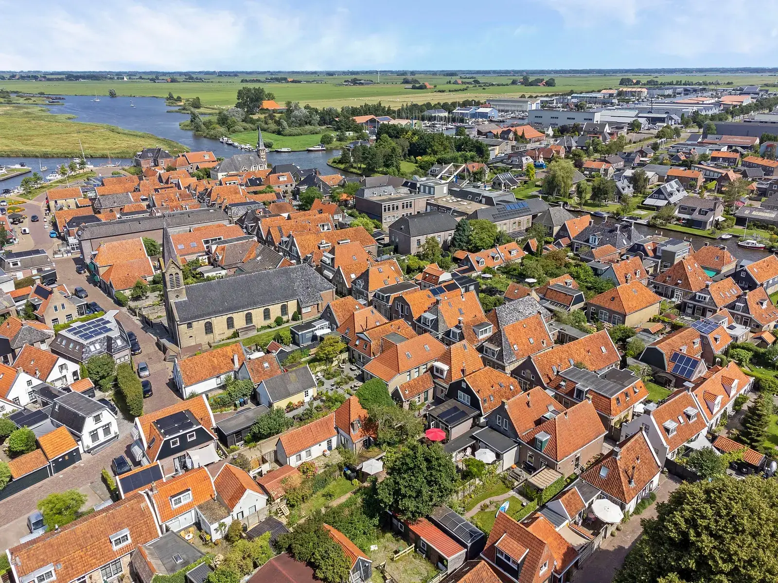 Luchtfoto van Woudsend met de rode daken en het water